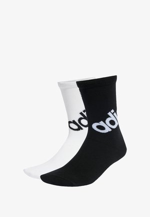 Dos pares de calcetines de tipo crew, uno negro y otro blanco, cada uno con el logo de "adidas" en un color contrastante. Fabricados con un tejido suave y elástico.