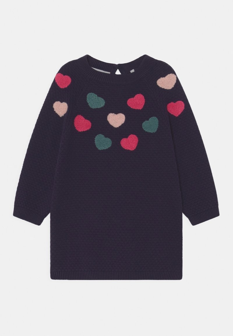 Navy neulemekko, jossa on kuvioitu pinta, ja rinnassa sekä hartioilla on monivärisiä sydänkoristeita vaaleanpunaisena ja vihreänä.