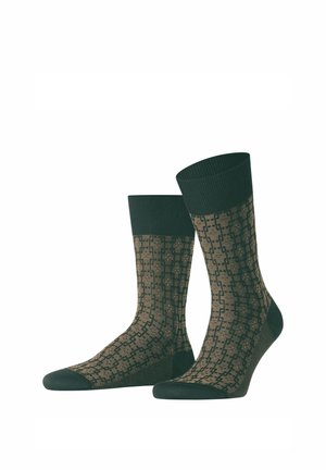 Chaussettes vert foncé à motifs avec un revers côtelé, présentant un design géométrique en nuances de brun. Confectionnées en tissu doux et extensible.