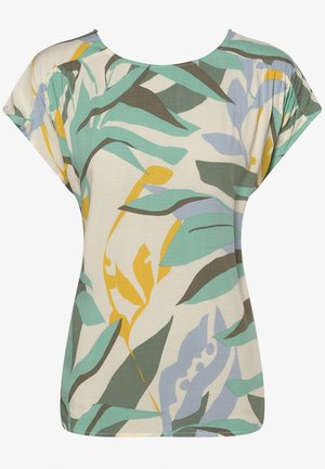 T-shirt à manches courtes en tissu léger, arborant un fond crème avec des motifs de feuilles abstraits verts, jaunes et bleus. Coupe décontractée.