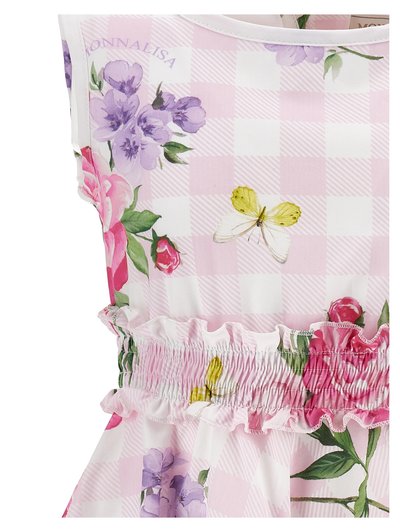 Ύφασμα ροζ και λευκό με καρό σχέδιο, διακοσμημένο με μοβ και ροζ λουλούδια, πράσινα φύλλα, κίτρινες και λευκές πεταλούδες και λεπτομέρεια με πιεταρισμένη βολάν.