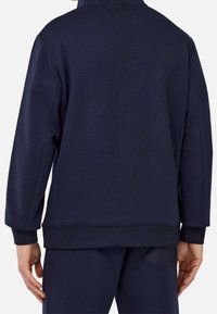Navy blue sweatshirt with a rounded collar, ribbed cuffs, and hem, featuring a small logo at the back, made from textured cotton material.