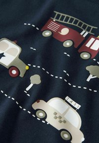 Katoenen stof met een wegenpatroon en kleurrijke voertuigen: een brandweerwagen, politiewagen en taxi, tegen een donkerblauwe achtergrond.