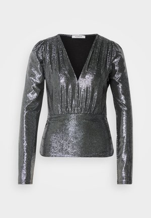 Shimmering silver long-sleeve blouse with a deep V-neck, gathered waist, and smooth texture. Reflective surface highlights the garment's shape.