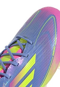 Blue and pink soccer shoe with a textured upper, featuring green accents, thin laces, and a streamlined design. Includes "SPRINTFRAME" branding.