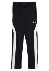 Černé sportovní kalhoty s bílými bočními pruhy, elastickým pasem a logem Jordan na levém stehně; vyrobené z syntetického materiálu, hladká textilie.