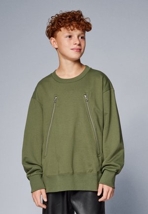 Olivgrüner Sweatshirt mit rundem Ausschnitt, langen Ärmeln und zwei vertikalen Reißverschlusstaschen auf der Vorderseite. Weicher Stoff.