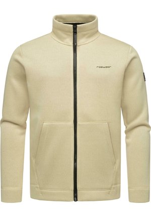 Veste zippée beige avec un col montant et deux poches avant. Le tissu texturé et les détails du zip noir améliorent le design.