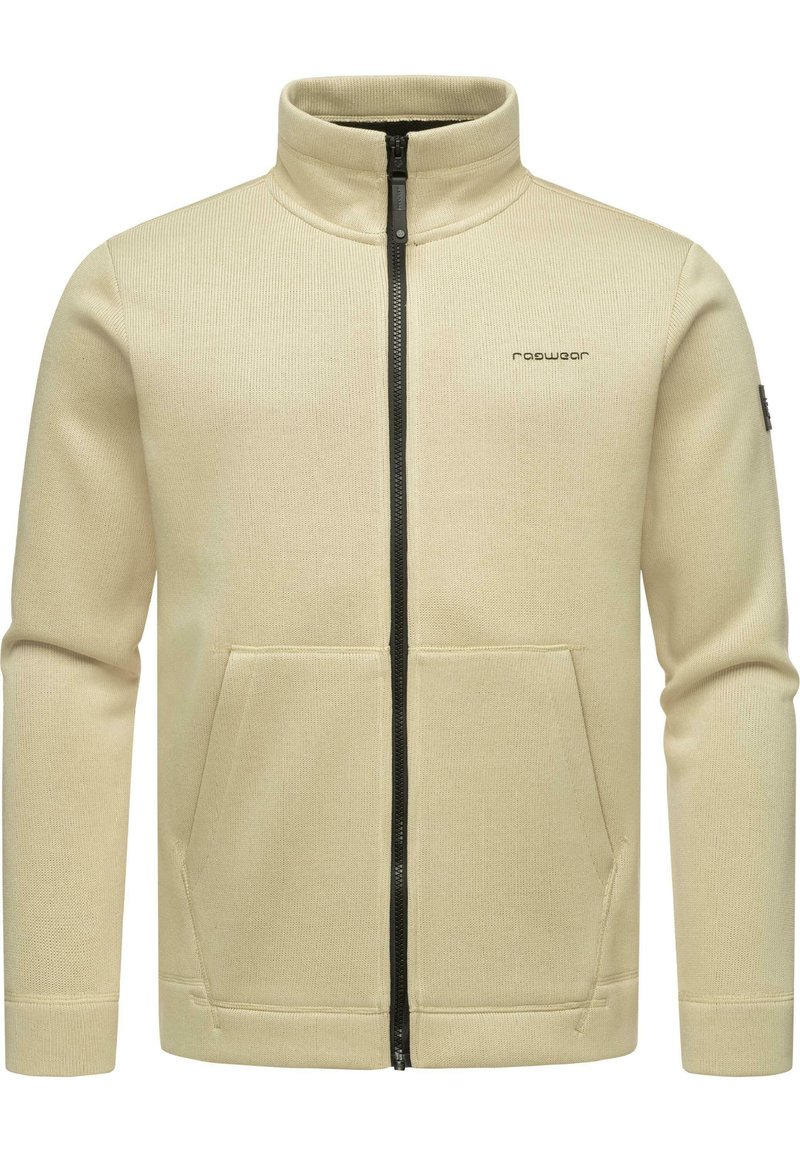 Beige zip-up jas met een hoge kraag en twee voorkanten zakken. Textuurstof en zwarte ritsdetails verhogen het ontwerp.