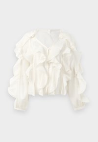 Hvit bluse laget av lett stoff med fremtredende volangdetaljer, V-hals og lange puffede ermer med knappeåpning.