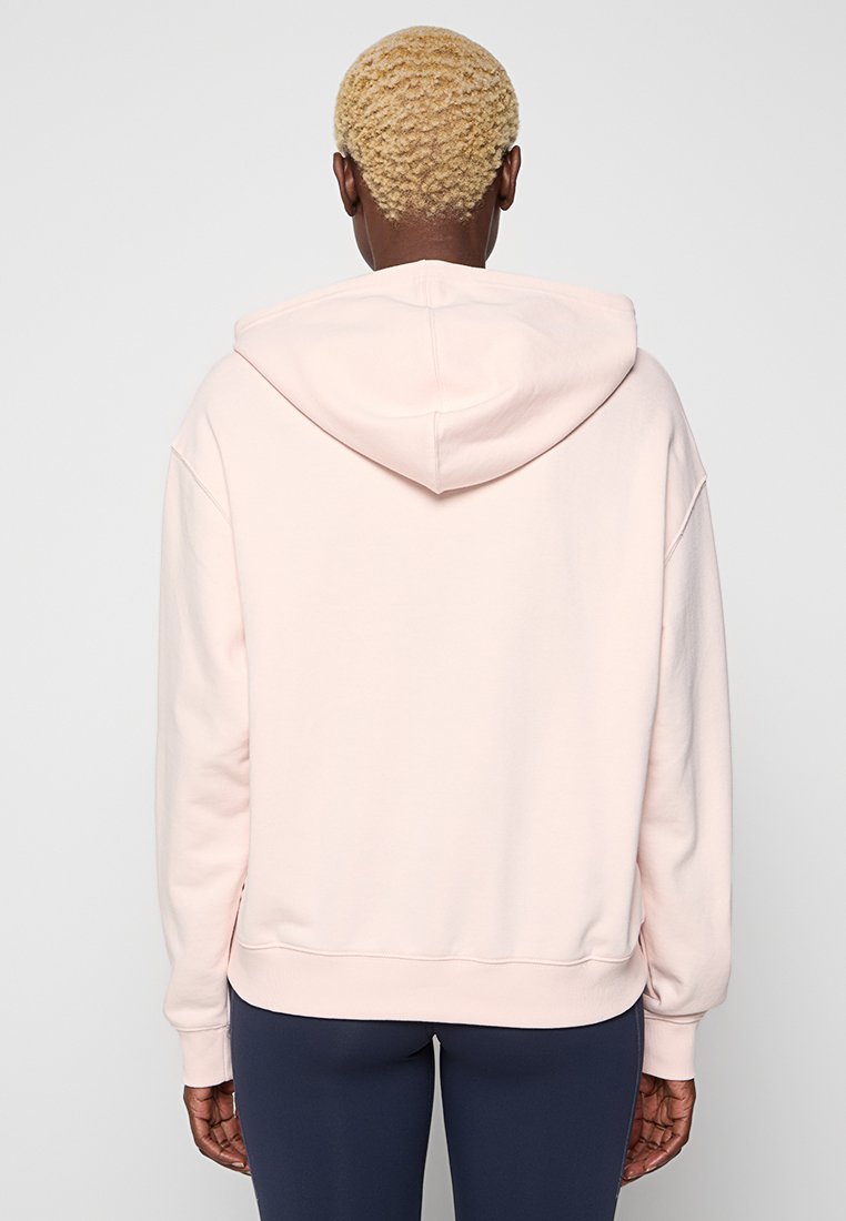 Sudadera con capucha de color rosa claro, de corte relajado, con puños y dobladillo acanalados, y capucha ajustable con cordón. Tejido de mezcla de algodón suave, con detalles mínimos.