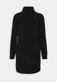 Svart stickad klänning med hög krage, långa ärmar och avslappnad passform. Har ett texturerat tyg och en fåll som når mitt på låret.