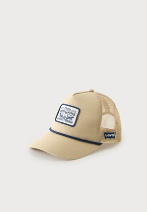 Beige truckerpet met mesh achterkant, navy bies, Levi's-logo aan de zijkant en een patch aan de voorkant met Levi Strauss & Co branding.