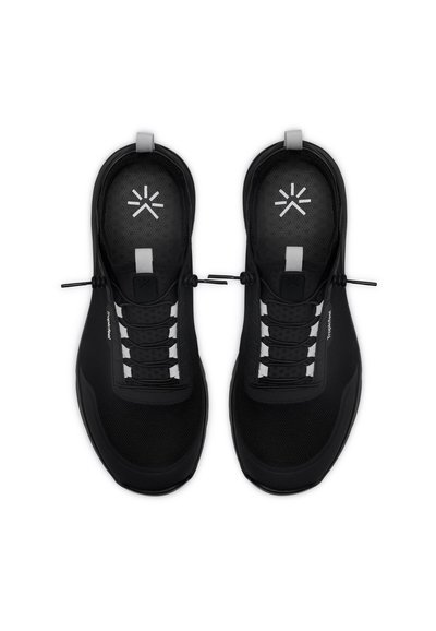 Black athletic shoes with a mesh upper, rubber sole, and elastic laces. Features a rounded shape and small white accents on the tongue.