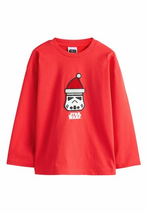 Red cotton long-sleeve t-shirt featuring a graphic of a stormtrooper wearing a Santa hat and "STAR WARS" text below the design.