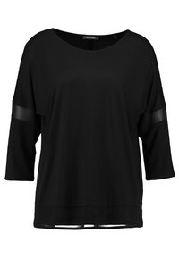 Schwarzes, locker sitzendes Oberteil mit Dreiviertelärmel, das durchsichtige Paneele an den Ärmeln und einen abgerundeten Halsausschnitt aufweist. Weiche Stofftextur.
