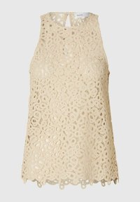 Blonde blonde top i lys beige med et blomster mønster, bølget kant og en nøglehuludskæring bagpå. Blød tekstur.