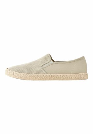 Beige slip-on shoe with woven sole, mesh fabric front, and solid fabric around heel, displayed in side profile.