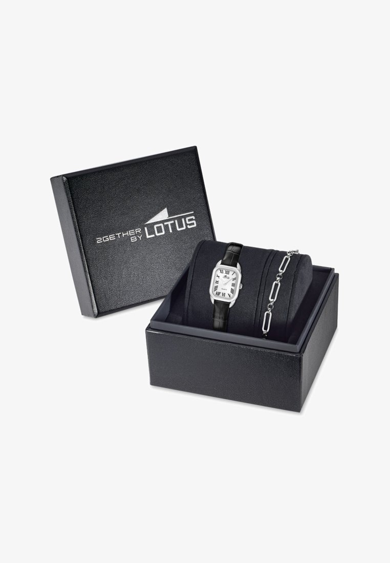 Silver rectangular watch with a black leather strap in a black textured box, accompanied by a silver chain bracelet with oval links.
