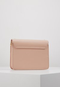 Pink faux leather handbag with a rectangular shape, flap closure, clean lines, and subtle stitching. Includes a gold-tone hardware accent.