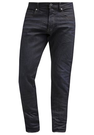Jeans in denim blu scuro con vestibilità slim, design a cinque tasche, cuciture a contrasto e chiusura con bottone in vita.