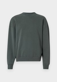 Mörkgrön sweatshirt med rund halsringning, långa sänkta ärmar och ribbade muddar och nederkant. Tyget är en bomullsblandning med en slät textur.