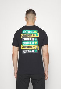 Nike Golf Triko s potiskem - black