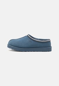 Blue suede slip-on shoe with a rounded toe, contrasting trim, and a textured outsole for grip. Features stitched detailing.