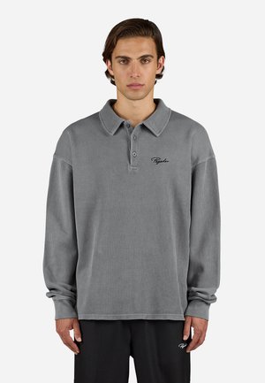 Grey long-sleeve polo shirt with a ribbed texture, buttoned collar, and embroidered logo on the chest, featuring relaxed fit sleeves.