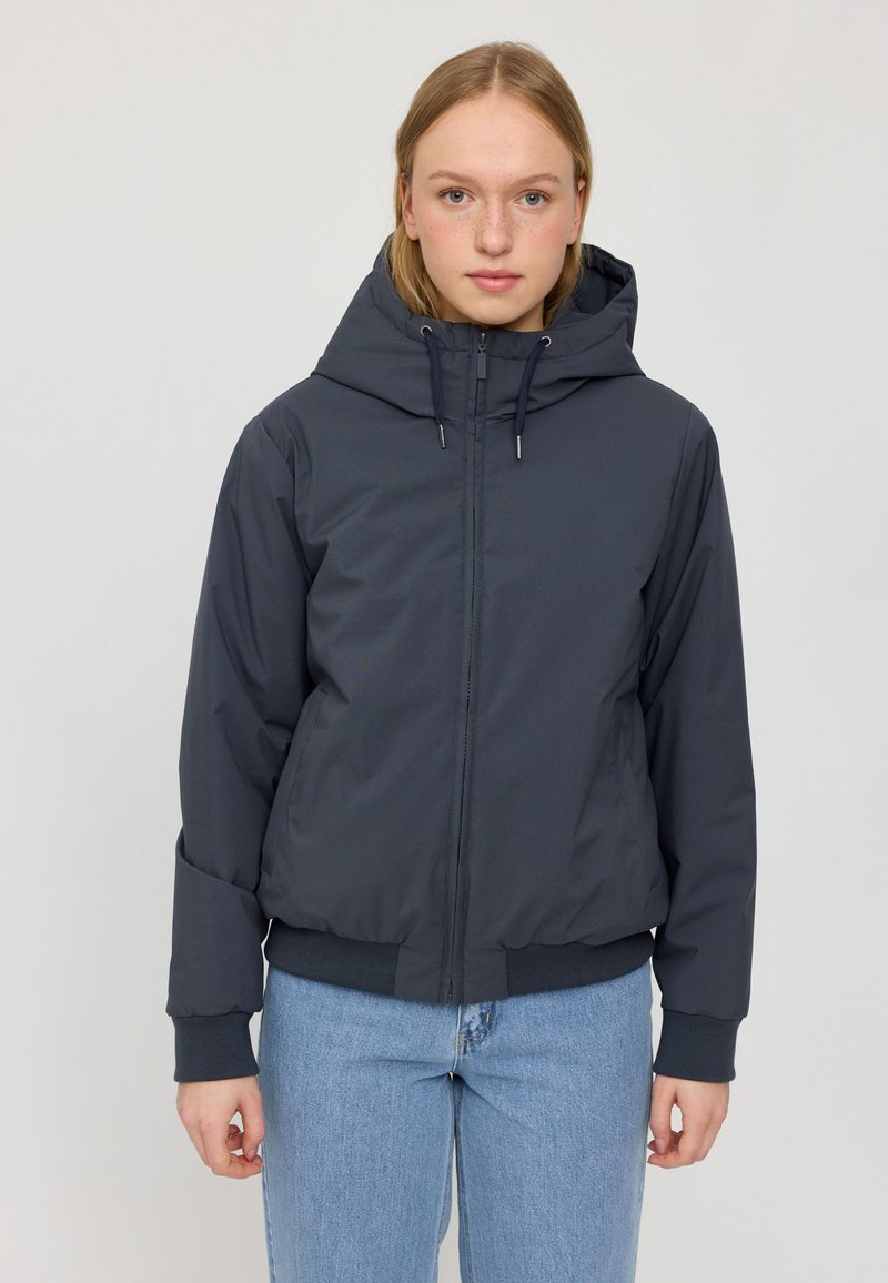 Navy blue insulated jacket with hood, featuring a front zipper, elastic cuffs, and a fitted hem. Smooth texture, lightweight design.