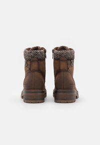 Brown leather boots with a knitted cuff, featuring a side zip, round toe, textured upper, and a sturdy rubber sole.