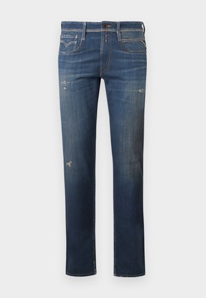 Dark blue denim jeans with a straight leg, featuring distressed areas, subtle fading, and traditional five-pocket design with a button closure.