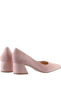 Ett par rosa mocka pumps med blockklackar, spetsiga tår och låga, breda klackar, visade från sidan och bakifrån.