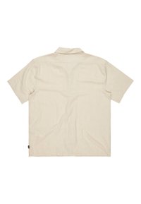 Kortærmet skjorte med krave i lys beige stof. Har en afslappet pasform, minimal tekstur og et lille sidetags ved kanten.