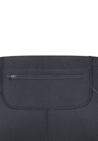 Pantalons de sport noirs avec une texture lisse, dotés d'une poche zippée dissimulée à l'arrière et de coutures renforcées le long des coutures.