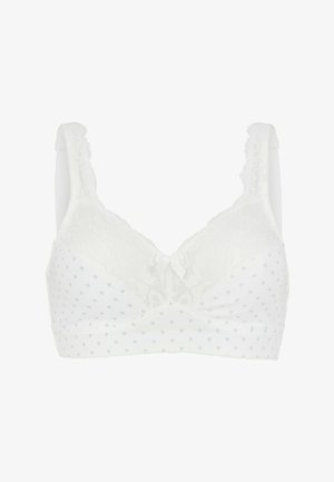 Vit bh med spetsövre kupor, prickigt mönster, scallopade axelband samt en liten rosett i mitten. Mjukt tyg med texturerade detaljer.