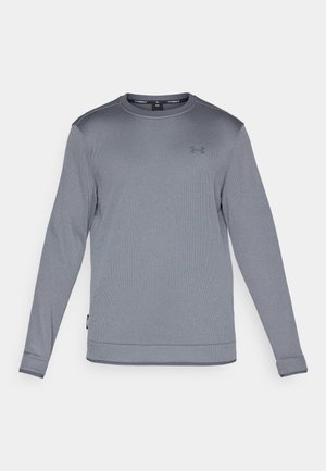 T-shirt de sport à manches longues gris, fabriqué en tissu texturé, avec un col rond, arborant un petit logo sur la poitrine et des poignets côtelés.