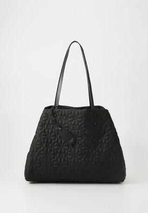 Black quilted tote bag with floral pattern stitching and two thin shoulder straps against a plain background.
