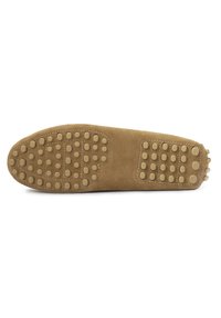 Brown suede shoe sole with rounded rubber studs for traction. Contoured shape with stitching detail along the edges.