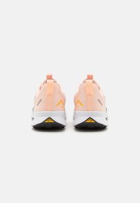 Sport shoes featuring a lightweight mesh upper in pink, white midsole, black outsole, and orange accents. Design includes heel pull tab.
