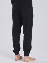 Schwarze Jogginghose aus einem weichen Baumwollgemisch, mit elastischem Bund und Bündchen, in lockerem Schnitt und ohne sichtbare Designelemente.