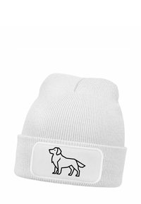 White knit beanie with a folded cuff. Features a rectangular patch with a black outline of a dog. Soft texture with ribbed design.