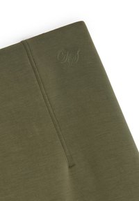 Tkanina w oliwkowym kolorze o gładkiej fakturze, z delikatnie wytłoczonym logo i starannie wykończonymi krawędziami. Prosty, nowoczesny design.