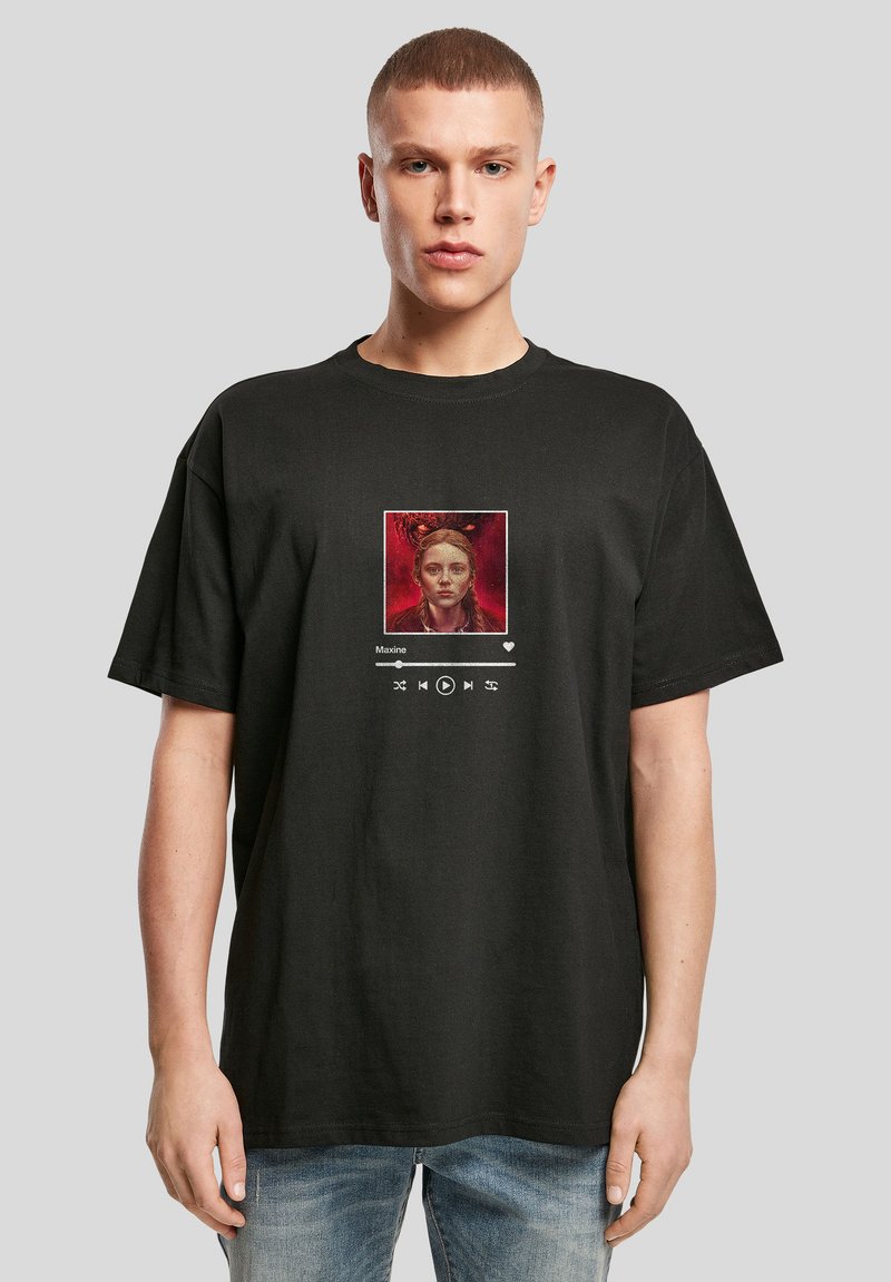 T-shirt en coton noir avec un visuel carré représentant l'image d'une femme, des contrôles de lecture et l'étiquette texte « Maxine » imprimée en blanc.