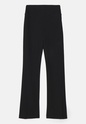 Black flared leggings with a high waistband, made of stretchy material. Smooth texture with no visible patterns or hardware details.