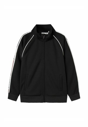Svart zip-up jacka med hög krage, med vita sidostråk och två framfickor. Tillverkad av ett slätt, stretchigt material.