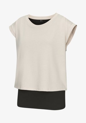 Beige short-sleeve top with a round neckline, layered over a black, fitted underlayer. Smooth texture, casual design, relaxed fit.