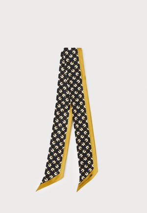 Écharpe en soie noire avec un motif géométrique de chaînes blanches et dorées, bordée d'un jaune moutarde, pliée en une boucle étroite.