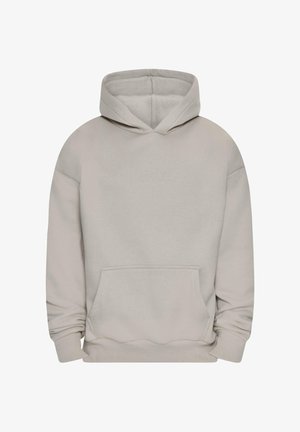 Bež kapuutsiga dressipluus, millel on nöör, tasku ning soonikkoes mansetid. Kude näeb välja pehme ning esipaneelil on õrn reljeefne logo.