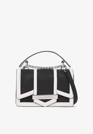 Black and white handbag with a structured design, made of leather. Features geometric patterns, a chain handle, and a silver logo accent.